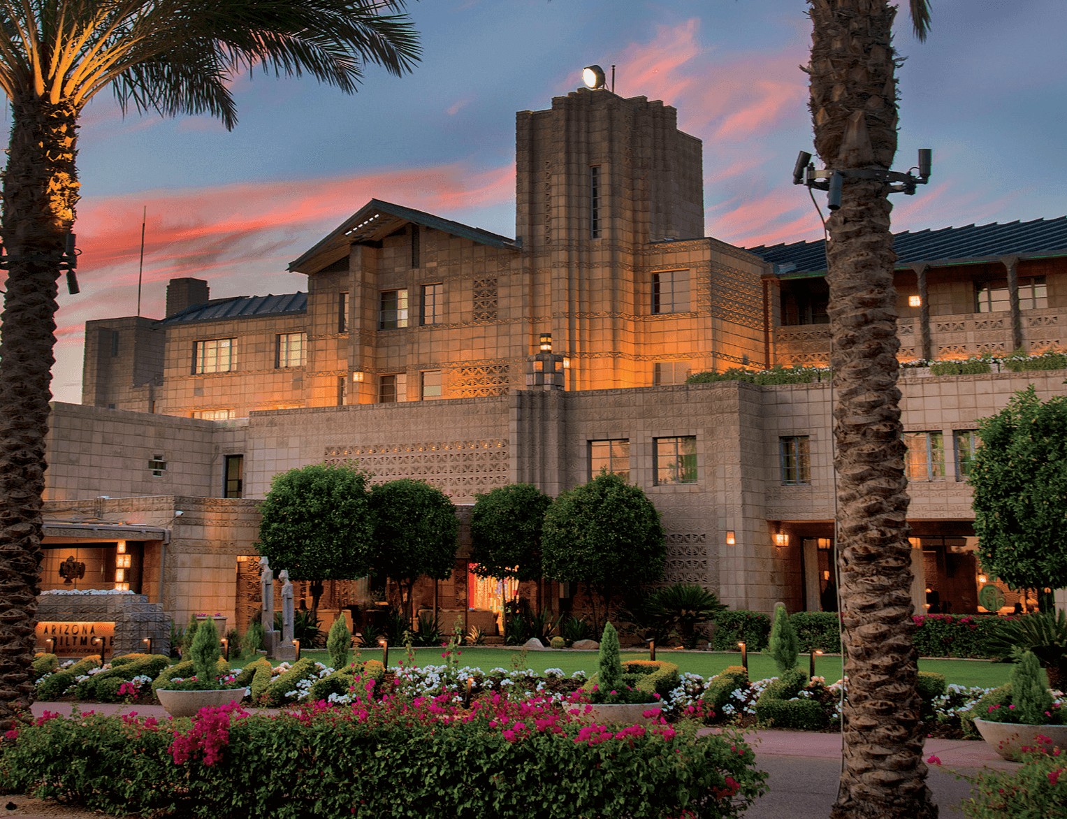 The historic Arizona Biltmore Hotel entrance and gardens at twilight