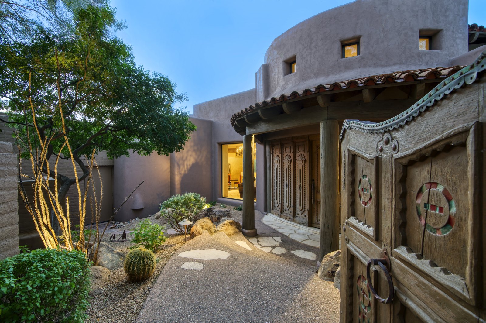 Carved wood gate entrance to a Southwest adobe-style North Scottsdale estate