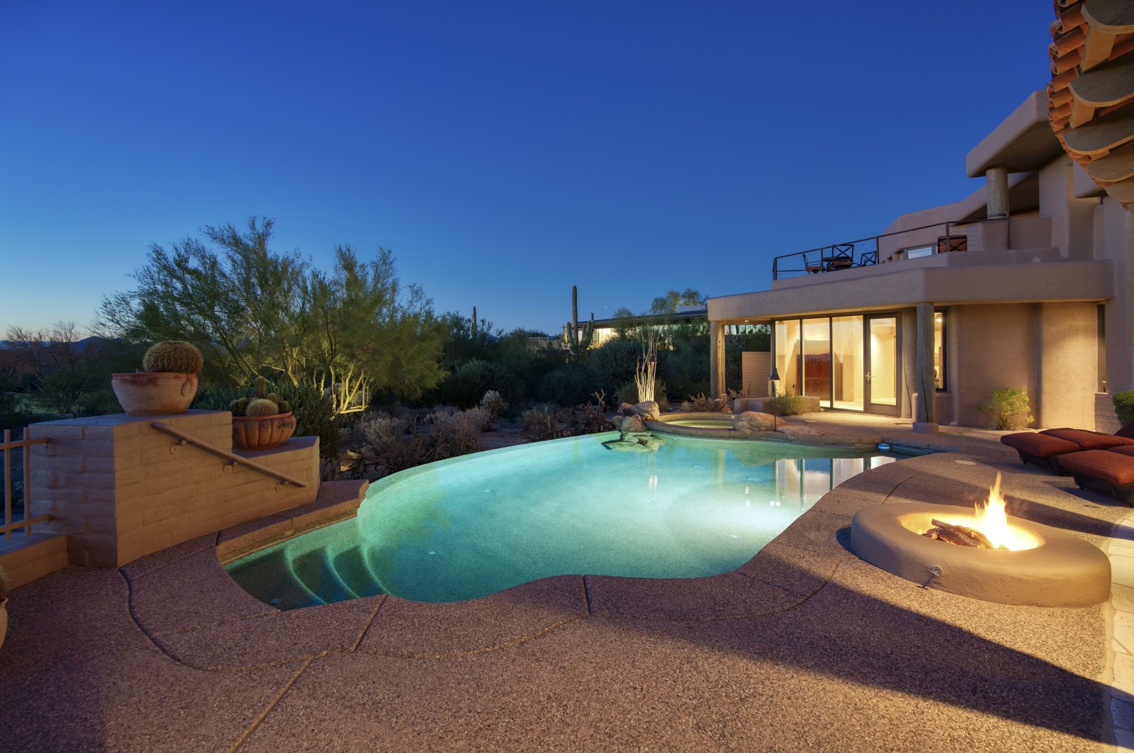 Twilight pool and fire pit at a North Scottsdale adobe-style estate